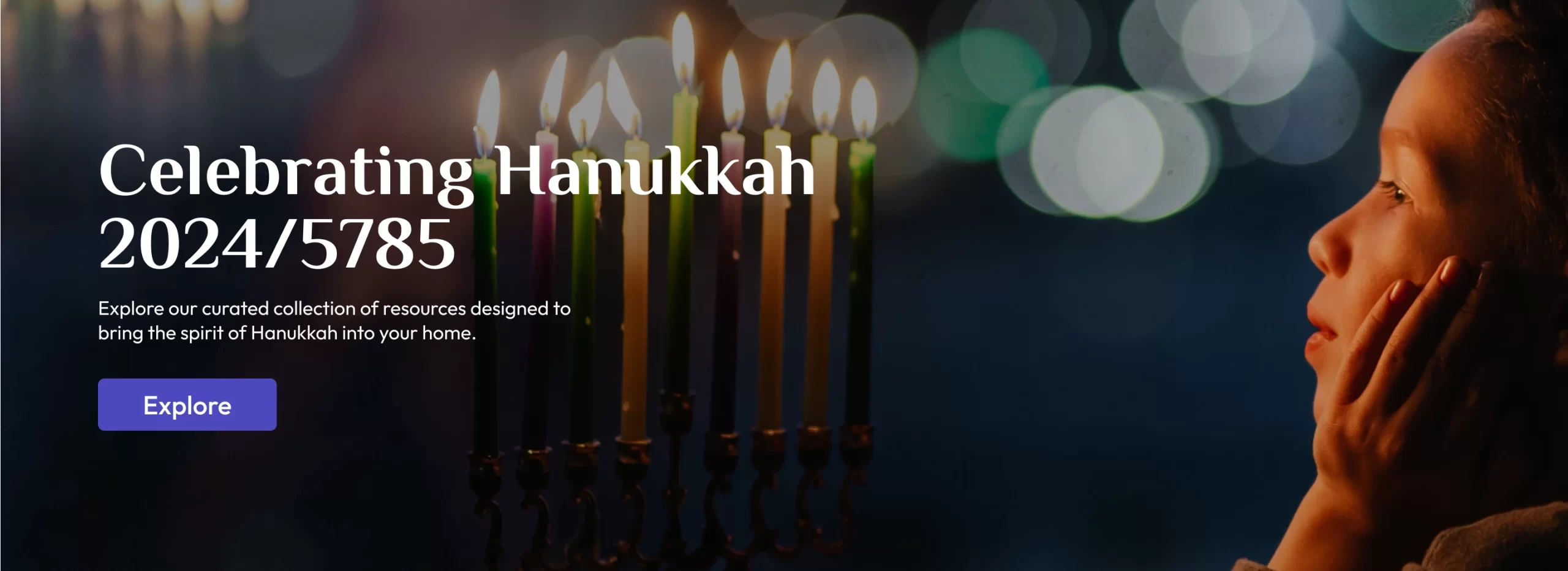 A child staring at a lit up menorah.