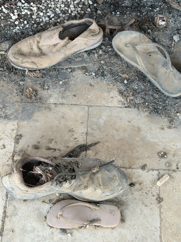 Shoes covered in dirt, left behind by victims of October 7 massacre.