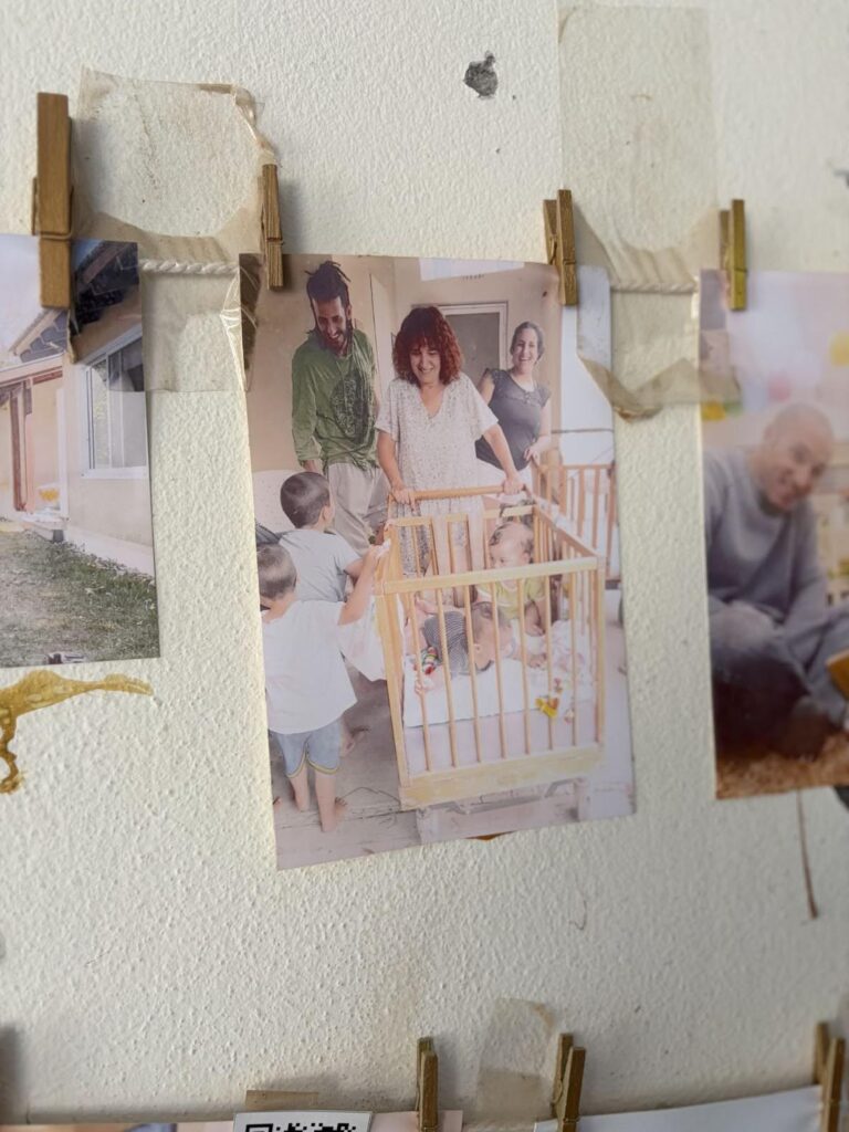 Photo on a clothesline depicting Maayan Bar playing with her grandchildren