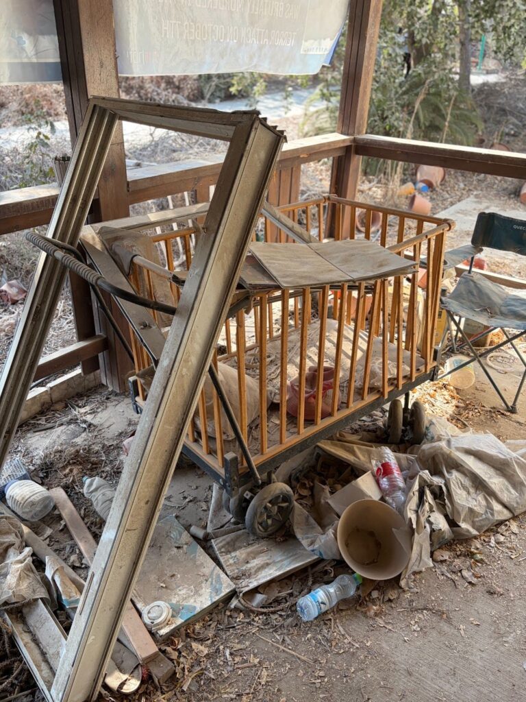 Crib surrounded by wreckage from October 7 massacre.